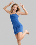 Young girl in a blue dress posing with peace signs on a gray background