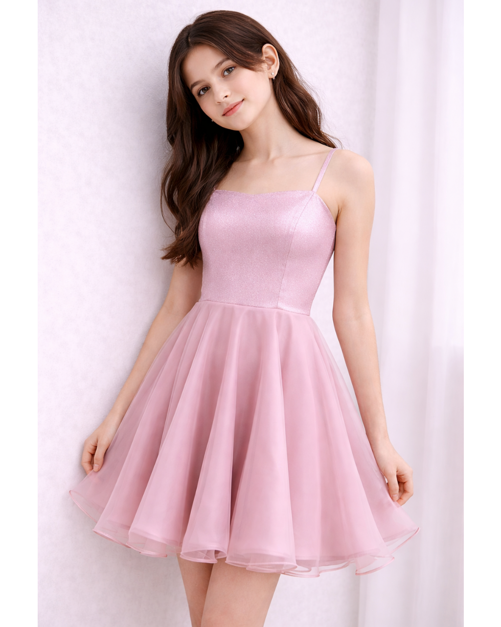 Girl wearing a pink dress against a white background
