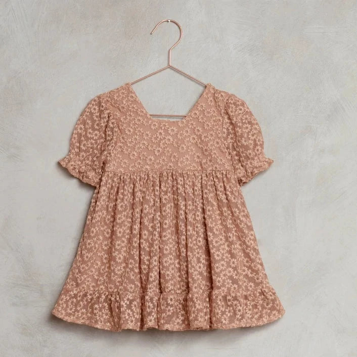 This adorable Noralee Quinn dress features pretty baby doll inspired silhouette with a square neck and button back closure. Ready to twirl, this dress has a fully lined bodice with sheer puff sleeves.